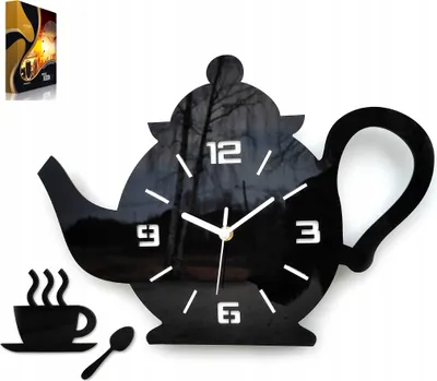 A black teapot-shaped clock with a cup and spoon accessory, displayed against a white background.
