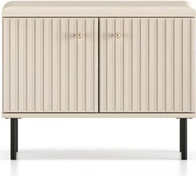 A front view of a two-door cabinet with fluted doors and gold knobs, standing on black legs.