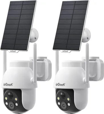 Two white and black outdoor security cameras with solar panels attached, shown against a white background.