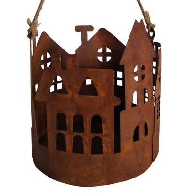 A hanging lantern shaped like houses, made of rusted metal.