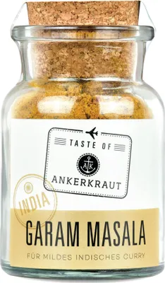 A glass jar of Garam Masala spice with a cork lid and a label.