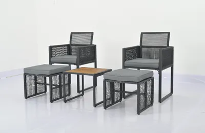 A set of outdoor furniture including two chairs, two ottomans, and a small table, arranged on a white background.