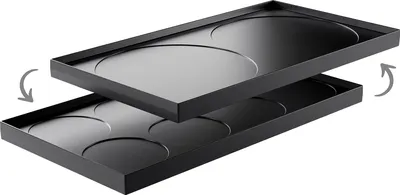 Two black metal trays with circular indentations, stacked on top of each other. The top tray is slightly offset to the left and angled downwards, with arrows indicating movement.