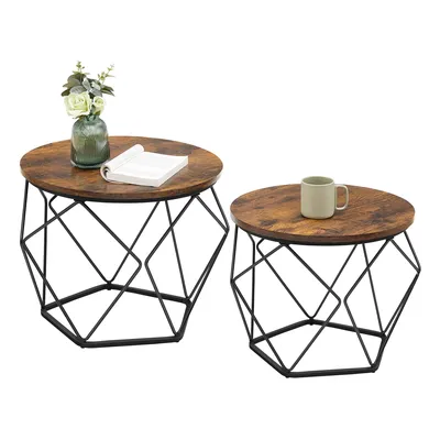 Two round coffee tables with vintage brown tops and black geometric bases are shown against a white background. One table has a vase with flowers and a book on it, while the other has a mug.