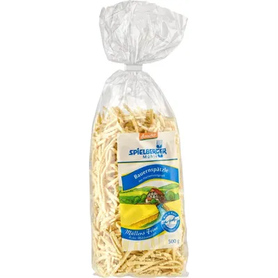 A bag of Spätzle pasta on a white background.
