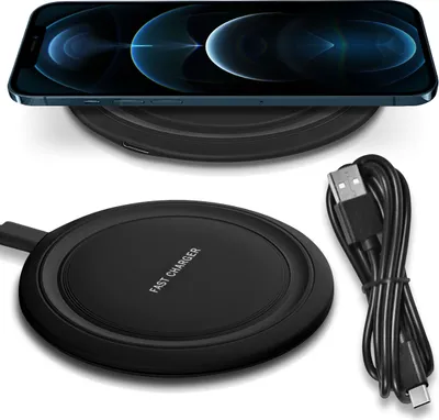 A black wireless charger with a USB-C cable and an iPhone 12 Pro placed on top of it.