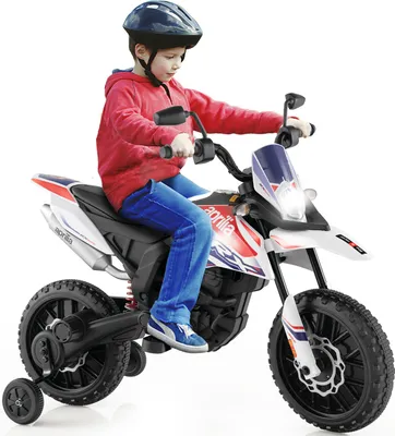 A young boy is riding a toy motorcycle.