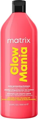 A pink bottle of Matrix Glow Mania shampoo with yellow text.
