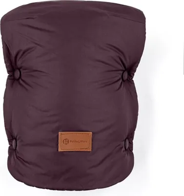 A close-up, front-facing view of a quilted, plum-colored baby bunting bag, with a small brown leather tag featuring a logo and text in the center.