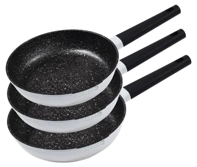 Three frying pans stacked on top of each other against a white background.