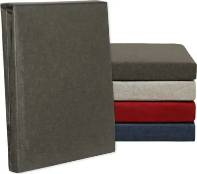 A stack of fitted sheets in different colors, with one sheet standing upright in the foreground.