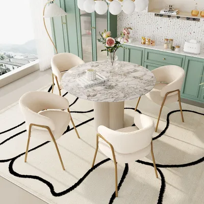 A dining set with a marble-top table and four cream-colored chairs placed on a rug with a black abstract pattern.