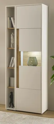 A modern white and wood tone cabinet with shelves and a glass vase.