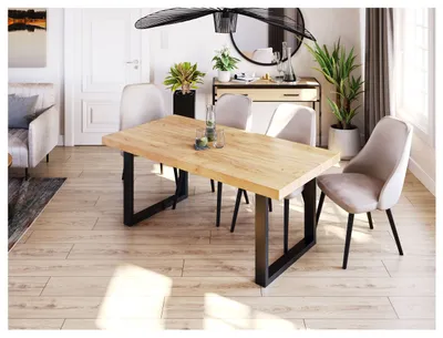 A dining room setting with a wooden table and chairs.