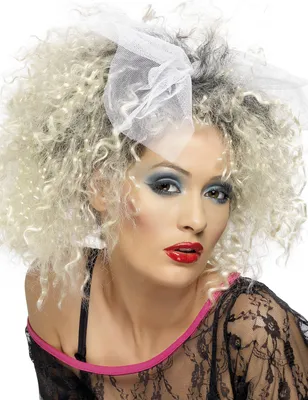 A woman wearing an 80s-style wig and makeup.