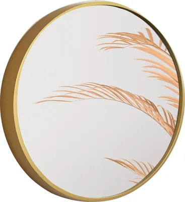 A round mirror with a gold frame, reflecting dried palm fronds.