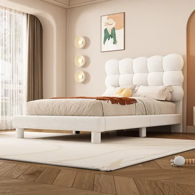 A white upholstered bed frame with a tufted headboard is shown in a bedroom setting.