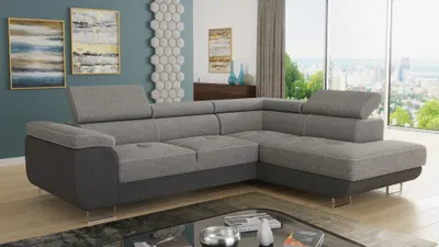 A modern living room with a large sectional sofa, artwork on the wall, and a city view through the window.