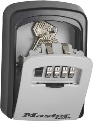 A close-up shot of a Master Lock key safe with the door open, revealing keys inside and a combination lock.