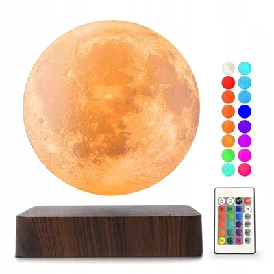 A floating moon lamp with a wooden base, a remote control, and a color swatch.