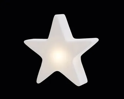 A white star-shaped lamp with a light source inside, set against a black background.