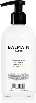 A white bottle of Balmain shampoo with a black pump dispenser.
