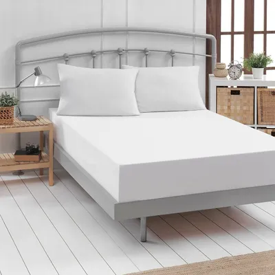 A white fitted sheet is shown on a bed with two white pillows.