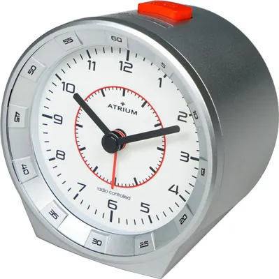 A close-up, studio shot of a silver analog alarm clock with a white face and red accents.
