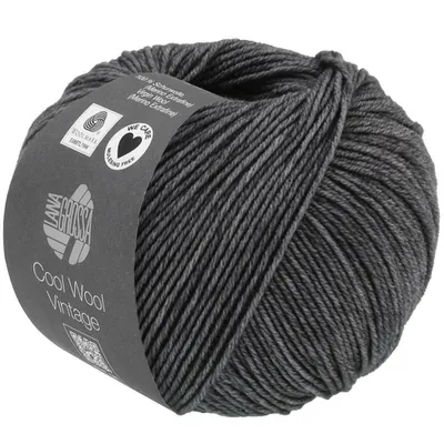 A ball of dark gray yarn with a label wrapped around it.