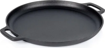 A black cast iron frying pan with two handles is shown from a slightly elevated angle against a white background.
