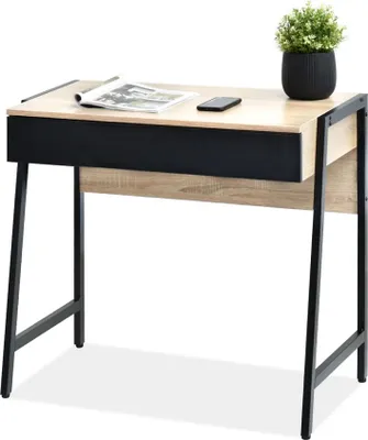 A desk with a drawer, a magazine, and a phone on top, with a potted plant in the background.
