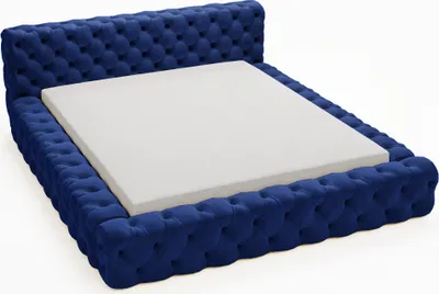 A blue tufted bed frame with a white mattress on a white background.