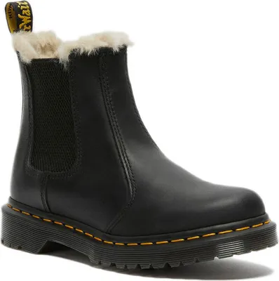 A black Dr. Martens boot with faux fur lining.