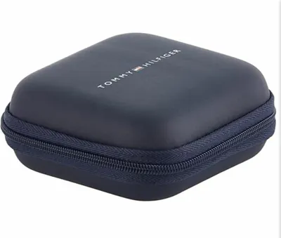 A closed navy blue jewelry box with the Tommy Hilfiger logo on top.