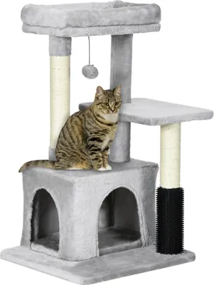 A cat sits on a multi-level cat tree with scratching posts and a hideaway.