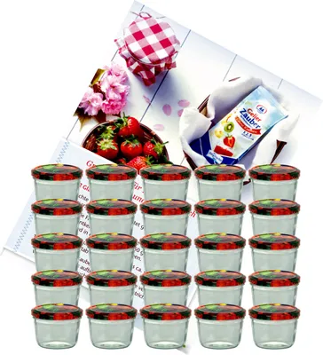 A collection of small glass jars with patterned lids, along with a packet of jam-making ingredients and some strawberries.