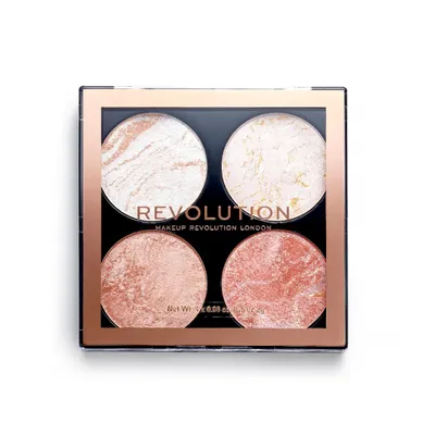 A top-down view of a makeup palette with four circular pans of highlighter.