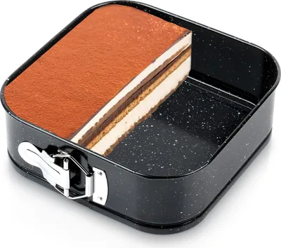 A slice of tiramisu cake sits in a black square springform pan.
