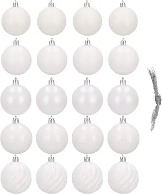 A collection of white Christmas ornaments arranged in rows against a white background.
