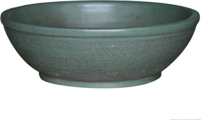 A green ceramic bowl is shown against a white background.