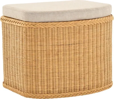A woven wicker storage ottoman with a cushioned top.