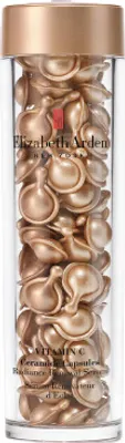 A clear, well-lit studio shot of a bottle filled with individual serum capsules.