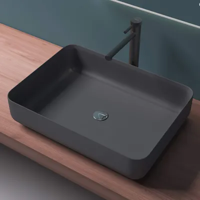 A modern bathroom sink on a wooden countertop.