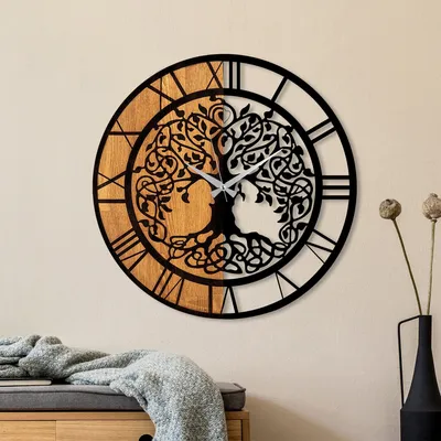 A decorative wall clock with a tree of life design.