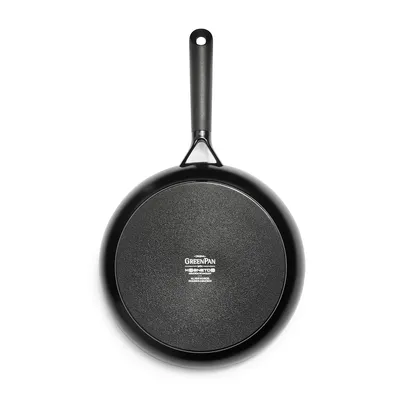 The back of a black frying pan on a white background.