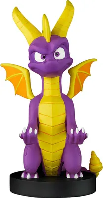 A purple and yellow dragon figurine with orange wings is sitting on a black circular base.