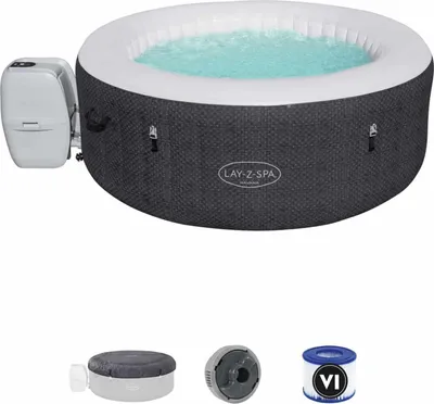 A Lay-Z-Spa hot tub with its control unit attached, shown from a slightly elevated angle. Below the hot tub are three accessories: a cover, a filter housing, and a filter cartridge.