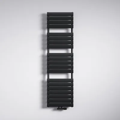 A black radiator is mounted on a white wall.