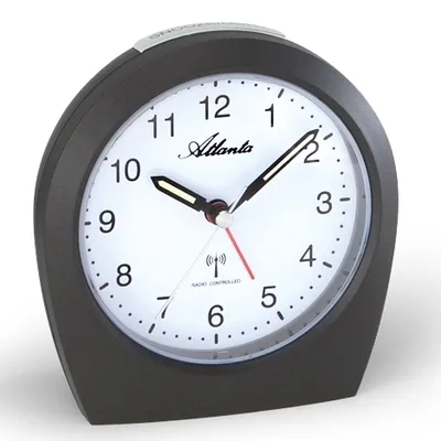 A close-up studio shot of a black alarm clock with a white face.