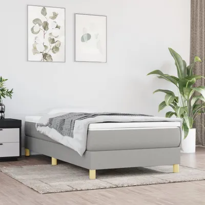 A bedroom scene with a bed, nightstand, and plant.